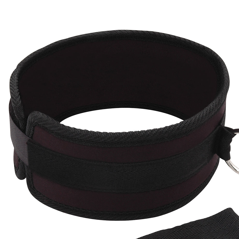 Black velcro collar with a strap on a white background