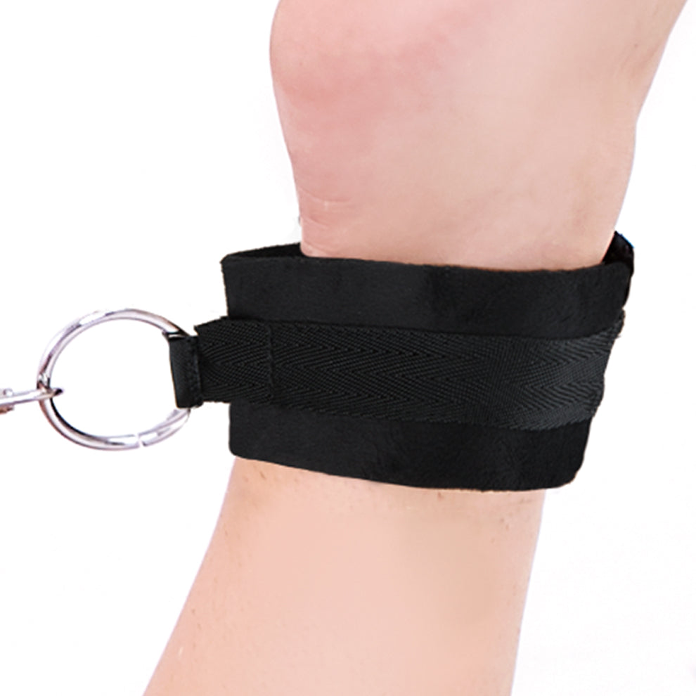 Black ankle restraint with a key on a white background
