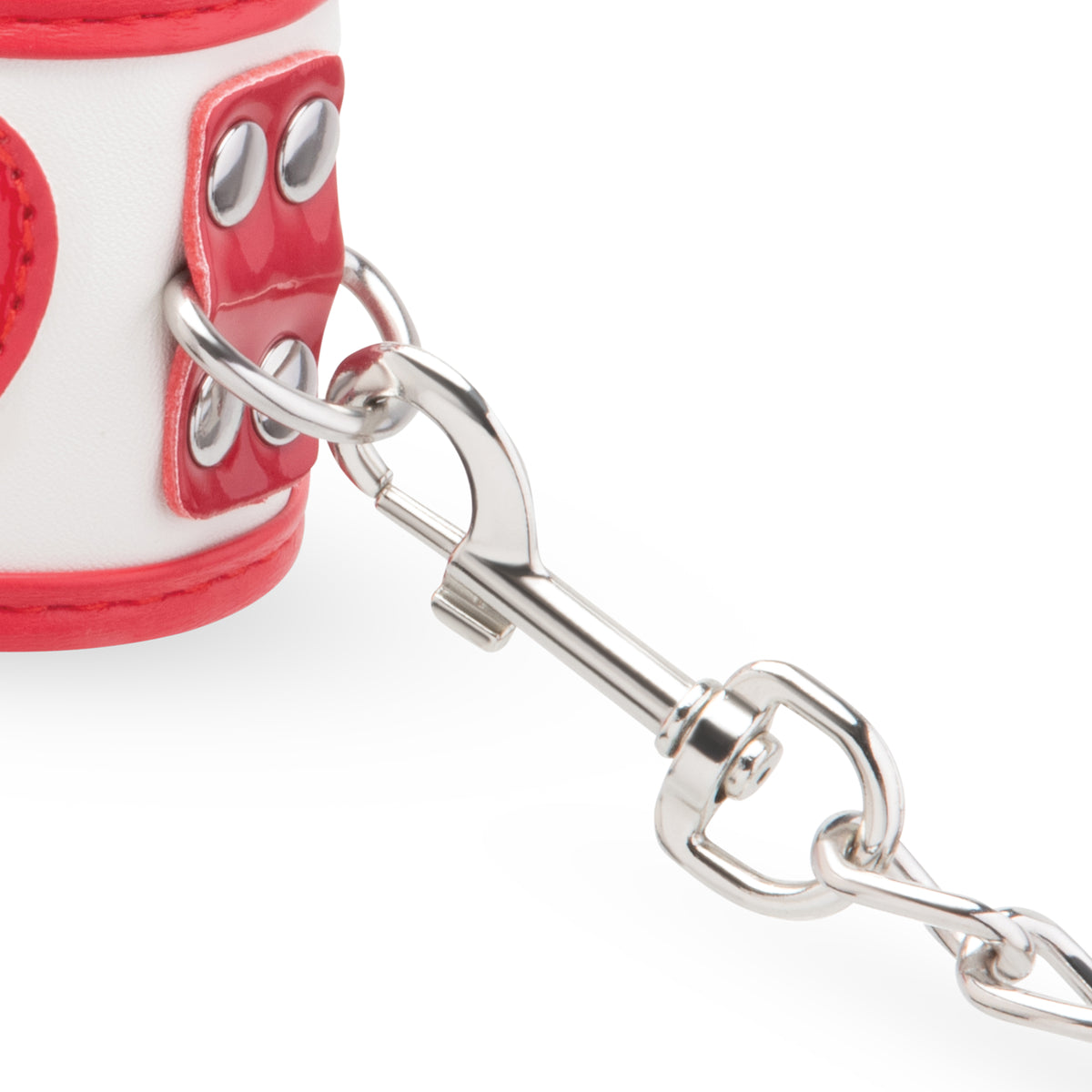 Close-up of a red and white cuff with a silver metal bit on a white background