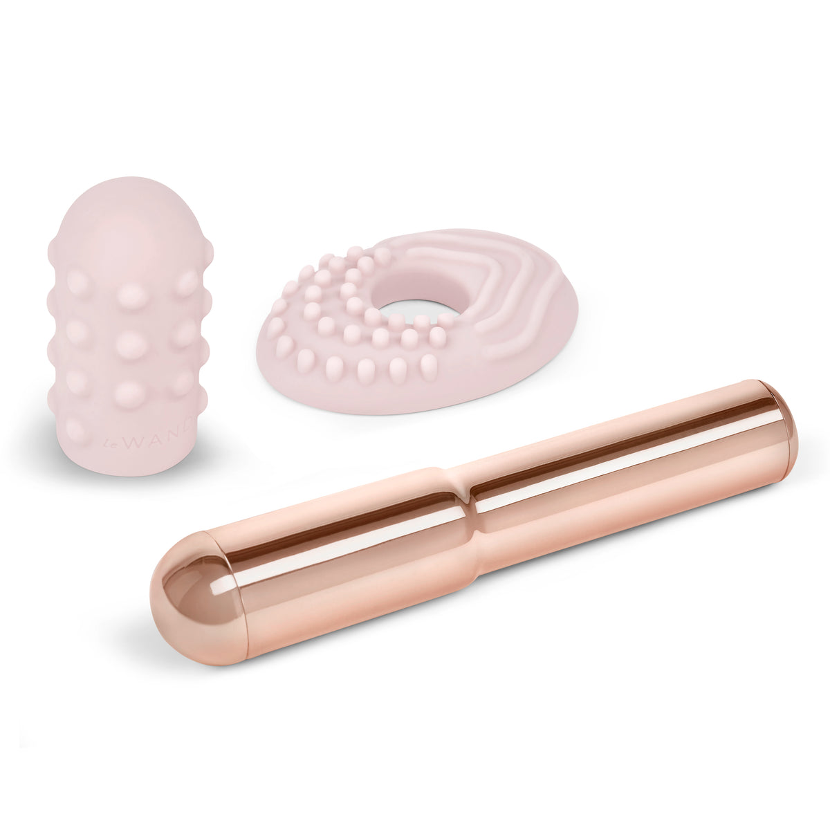 The metal wand lying next to the removed rose gold silicone textured sleeve, showing the two separate components.