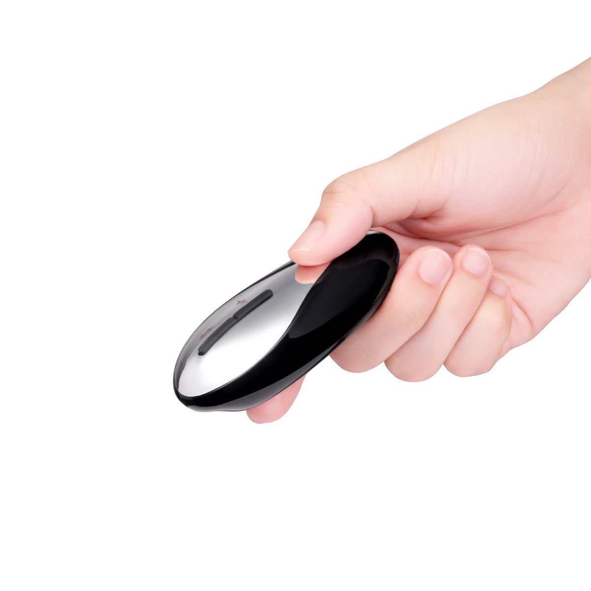 Hand holding a black and silver remote control against a white background