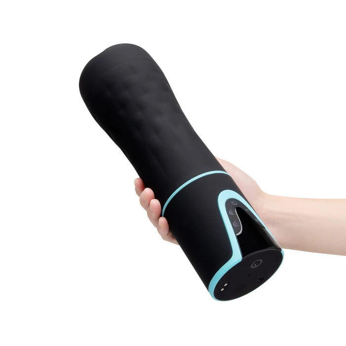 Hand holding the Rechargeable Suction Masturbator with a light on a white background