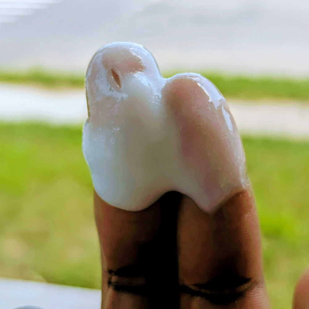 Hand with a dollop of The Butters Palm Grease Extra Greasy Unscented Lube
 on a blurred green background